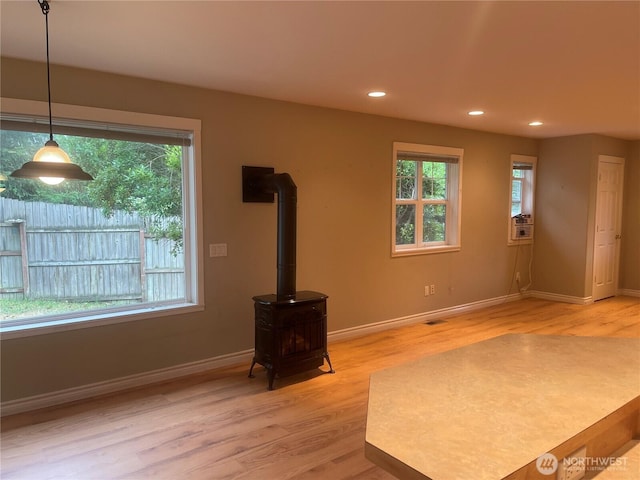 528 Chinook Way, Friday Harbor, WA 98250 - unfurnished living room featuring healthy amount of natural light, light wood-style flooring, recessed lighting, and a wood stove