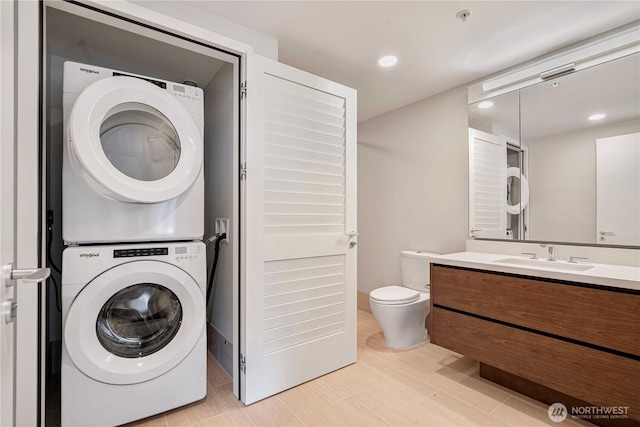 121 Stewart St Unit 3004, Seattle, WA 98101 - laundry area featuring stacked washer and clothes dryer and recessed lighting
