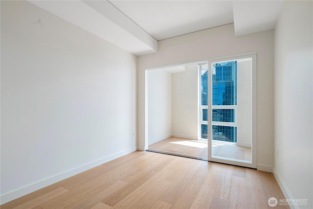 121 Stewart St Unit 3004, Seattle, WA 98101 - unfurnished room featuring wood finished floors and baseboards
