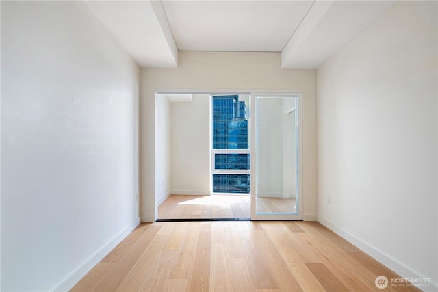 121 Stewart St Unit 3004, Seattle, WA 98101 - spare room featuring wood finished floors and baseboards