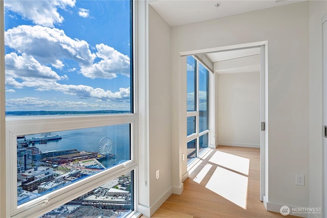 121 Stewart St Unit 3004, Seattle, WA 98101 - interior space featuring wood finished floors, baseboards, and a water view