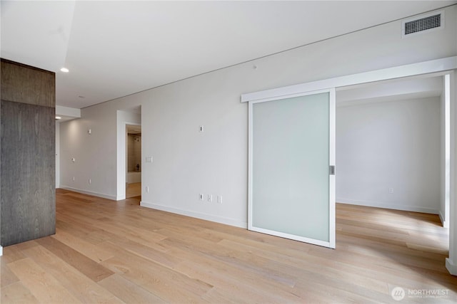 121 Stewart St Unit 3004, Seattle, WA 98101 - spare room featuring light wood-style flooring, recessed lighting, and baseboards