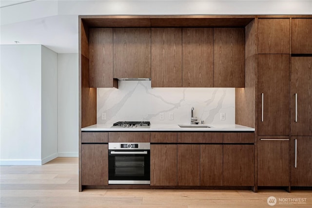 121 Stewart St Unit 3004, Seattle, WA 98101 - kitchen with appliances with stainless steel finishes, a sink, light countertops, and decorative backsplash