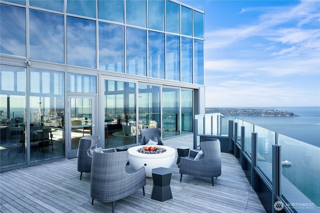 121 Stewart St Unit 3004, Seattle, WA 98101 - wooden deck with a fire pit and a water view