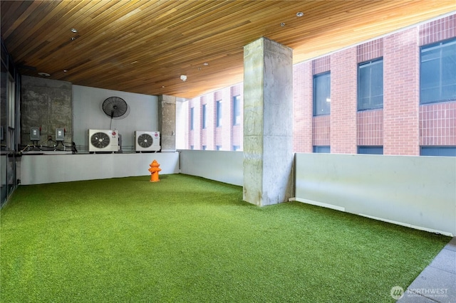 121 Stewart St Unit 3004, Seattle, WA 98101 - interior space featuring an area to practice putting, washer and dryer, wooden ceiling, and carpet flooring