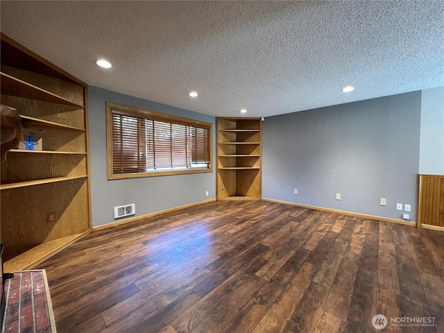 2116 E 65th St, Tacoma, WA 98404 - unfurnished living room with wood finished floors, a textured ceiling, built in features, baseboards, and recessed lighting