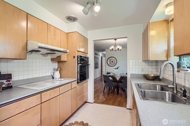 7924 S 112th St, Seattle, WA 98178 - kitchen featuring black oven, under cabinet range hood, a sink, white electric cooktop, and light brown cabinets