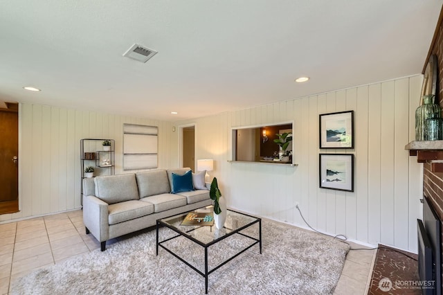 7924 S 112th St, Seattle, WA 98178 - living area featuring light tile patterned floors, recessed lighting, a fireplace, and wooden walls