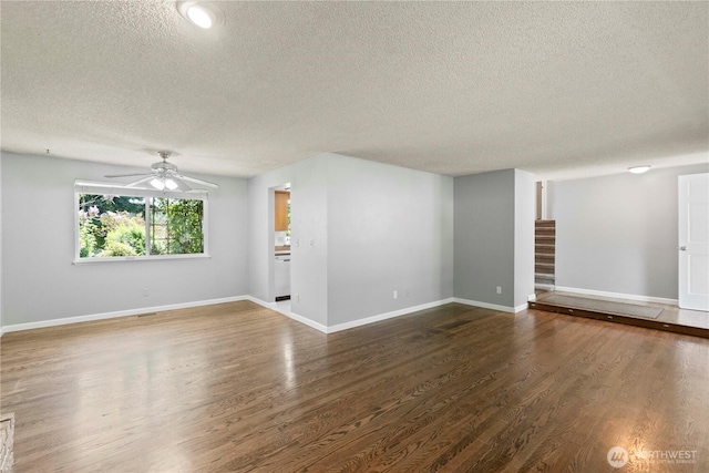 28713 SE 462nd Pl, Enumclaw, WA 98022 - unfurnished living room featuring a textured ceiling, stairs, a ceiling fan, wood finished floors, and baseboards