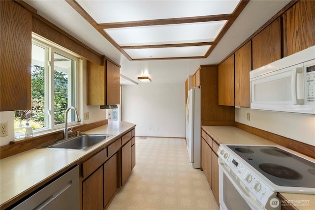 28713 SE 462nd Pl, Enumclaw, WA 98022 - kitchen featuring white appliances, a sink, light floors, light countertops, and brown cabinets