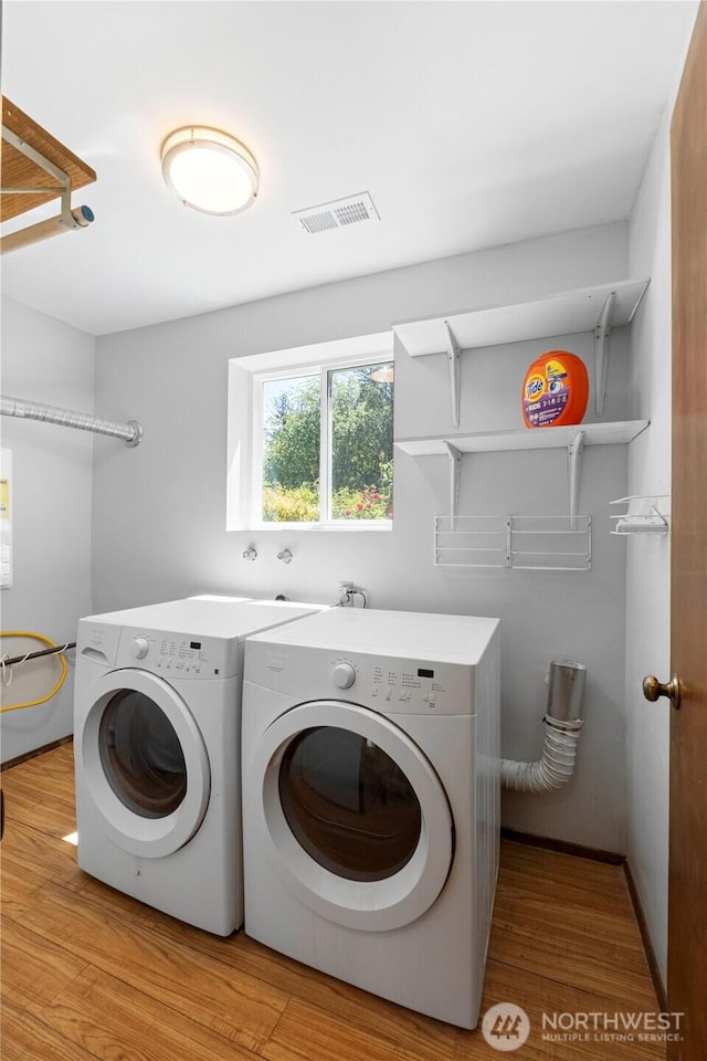 28713 SE 462nd Pl, Enumclaw, WA 98022 - washroom with washing machine and clothes dryer and light wood-type flooring