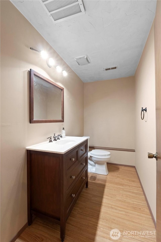 28713 SE 462nd Pl, Enumclaw, WA 98022 - bathroom featuring toilet, vanity, wood finished floors, and baseboards