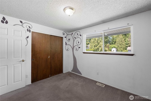 28713 SE 462nd Pl, Enumclaw, WA 98022 - unfurnished bedroom featuring a textured ceiling, a closet, and carpet floors