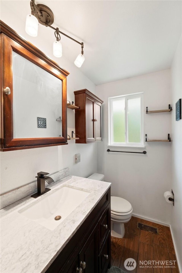 28713 SE 462nd Pl, Enumclaw, WA 98022 - bathroom with toilet, vanity, wood finished floors, and baseboards