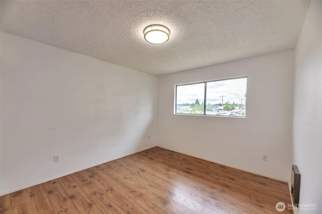 1702 C St SE, Auburn, WA 98002 - spare room with a textured ceiling and wood finished floors