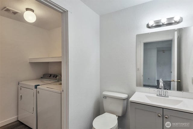 1702 C St SE, Auburn, WA 98002 - half bathroom with separate washer and dryer, vanity, and toilet