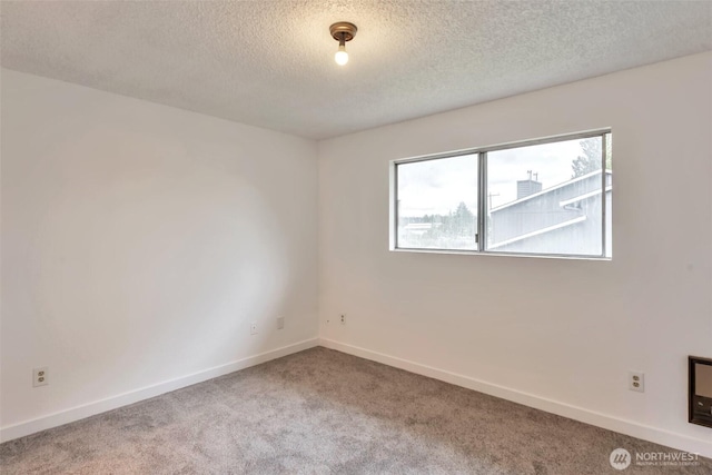 1702 C St SE, Auburn, WA 98002 - unfurnished room featuring carpet flooring, a textured ceiling, and baseboards