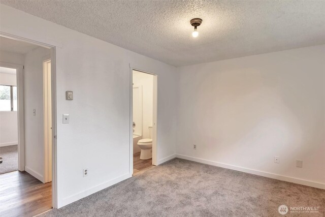 1702 C St SE, Auburn, WA 98002 - empty room featuring a textured ceiling, carpet flooring, and baseboards