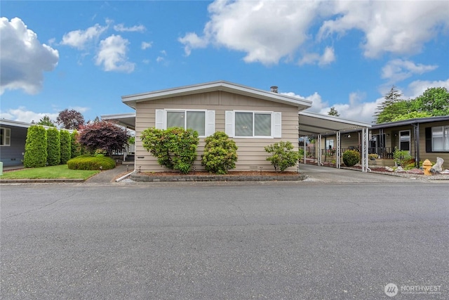 1402 22nd St NE Unit 47, Auburn, WA 98002 - manufactured / mobile home with a carport and driveway