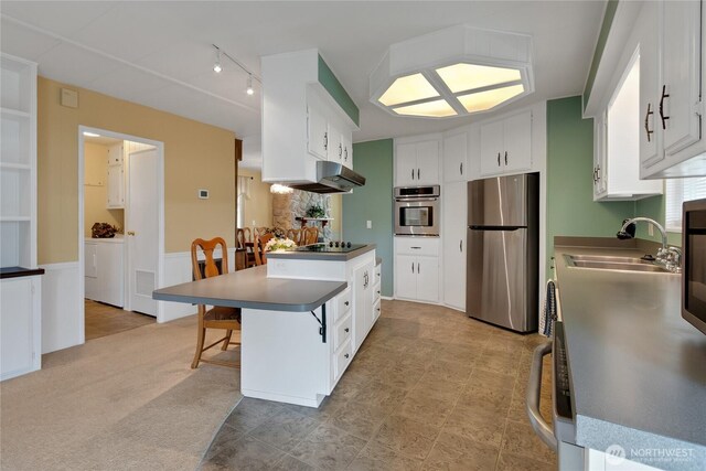 1402 22nd St NE Unit 47, Auburn, WA 98002 - kitchen with stainless steel appliances, a sink, white cabinets, extractor fan, and a peninsula