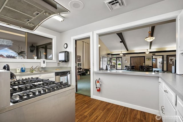 1402 22nd St NE Unit 47, Auburn, WA 98002 - kitchen with white cabinetry, dark wood-type flooring, light countertops, stainless steel appliances, and exhaust hood