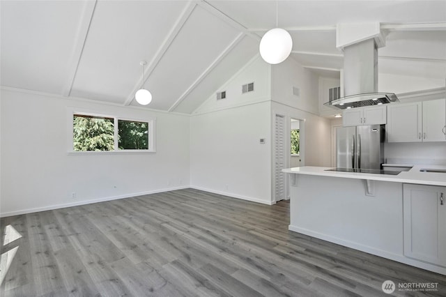 44251 Dalles Rd, Concrete, WA 98237 - unfurnished living room featuring healthy amount of natural light, beam ceiling, baseboards, high vaulted ceiling, and wood finished floors
