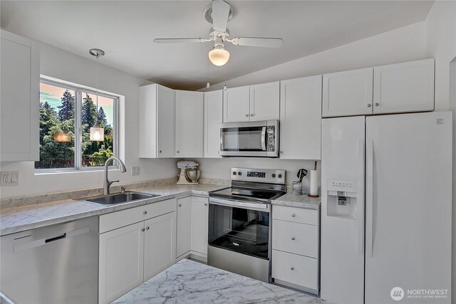 31006 38th Ave S, Auburn, WA 98001 - kitchen with stainless steel appliances, a sink, white cabinets, marble look tile flooring, and decorative light fixtures