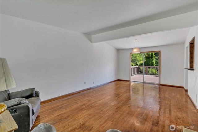31006 38th Ave S, Auburn, WA 98001 - unfurnished living room featuring baseboards and wood finished floors