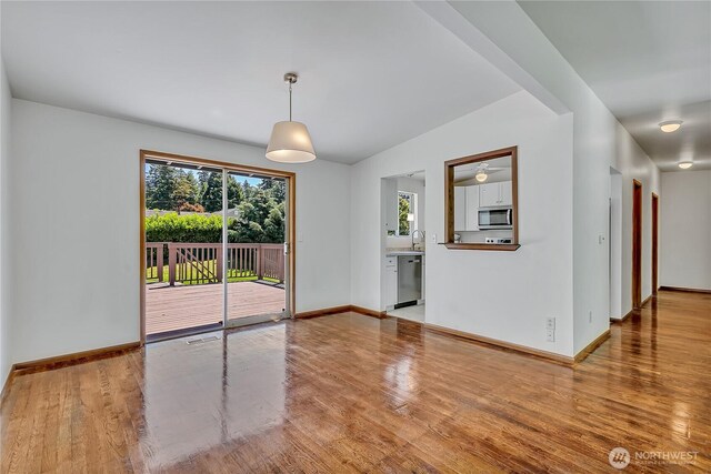 31006 38th Ave S, Auburn, WA 98001 - unfurnished dining area featuring wood finished floors, baseboards, ceiling fan, and lofted ceiling