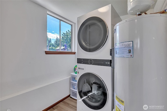 31006 38th Ave S, Auburn, WA 98001 - washroom with stacked washer and clothes dryer, water heater, wood finished floors, and baseboards