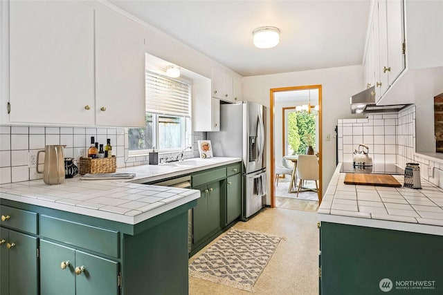 20010 3rd Ave NW, Shoreline, WA 98177 - kitchen with green cabinets, stainless steel fridge with ice dispenser, backsplash, and tile countertops