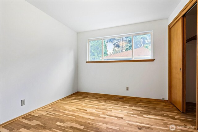 20010 3rd Ave NW, Shoreline, WA 98177 - unfurnished bedroom with light wood-style floors and a closet