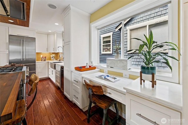 444 26th Ave E, Seattle, WA 98112 - kitchen with built in study area, butcher block counters, dark wood-style floors, recessed lighting, and white cabinetry