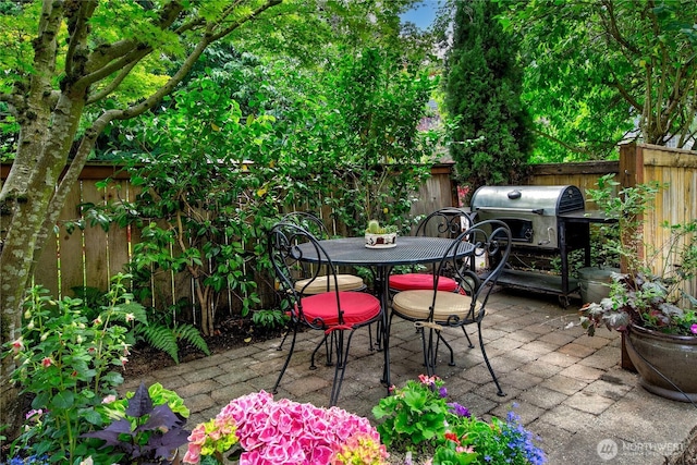 444 26th Ave E, Seattle, WA 98112 - fenced backyard with a patio, outdoor dining area, and a grill