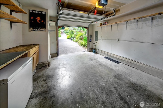 444 26th Ave E, Seattle, WA 98112 - garage featuring electric panel and a garage door opener