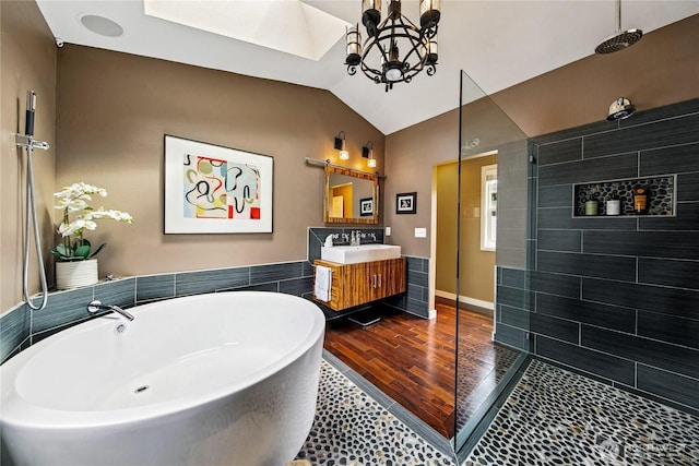 444 26th Ave E, Seattle, WA 98112 - full bathroom with a chandelier, a freestanding bath, vanity, a walk in shower, and lofted ceiling