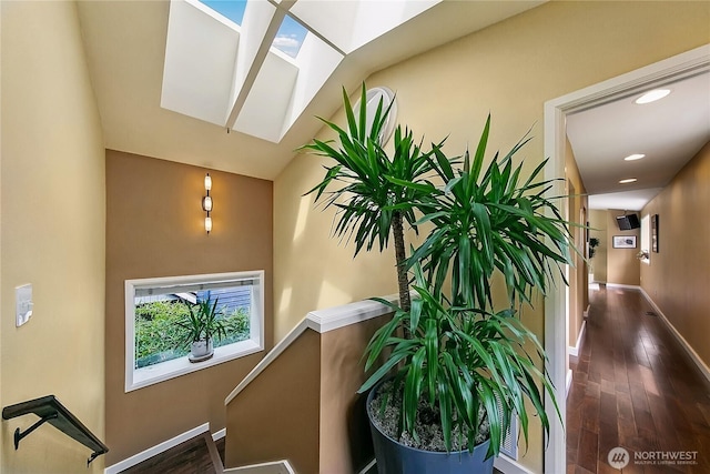 444 26th Ave E, Seattle, WA 98112 - stairs with wood finished floors, a skylight, recessed lighting, and vaulted ceiling