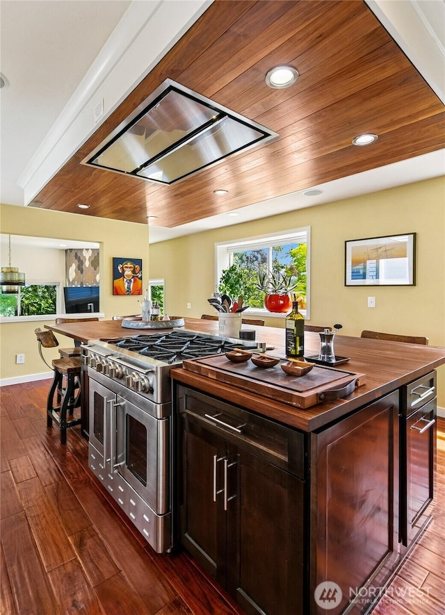 444 26th Ave E, Seattle, WA 98112 - kitchen featuring range with two ovens, butcher block counters, dark wood finished floors, dark brown cabinetry, and recessed lighting