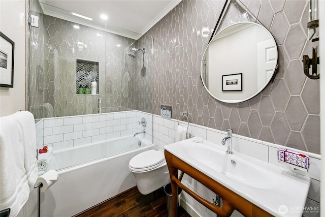 444 26th Ave E, Seattle, WA 98112 - bathroom featuring wood finished floors, tile walls, vanity, crown molding, and tub / shower combination