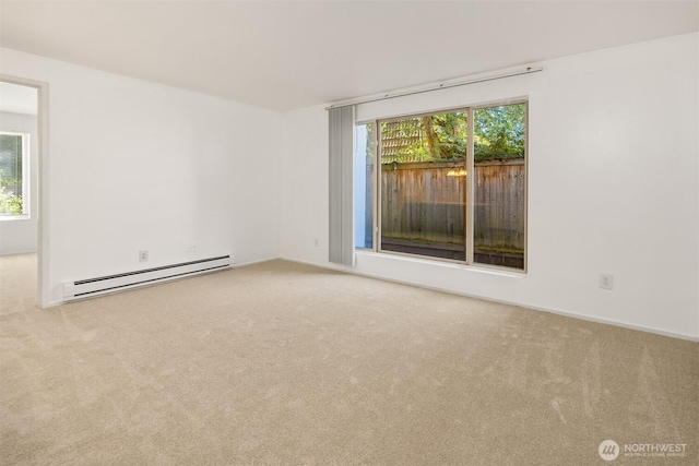 11012 NE 68th St Unit 511, Kirkland, WA 98033 - spare room with a baseboard radiator, carpet flooring, and healthy amount of natural light