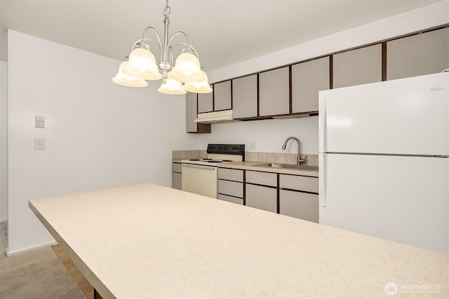 11012 NE 68th St Unit 511, Kirkland, WA 98033 - kitchen featuring white appliances, under cabinet range hood, a chandelier, light countertops, and hanging light fixtures