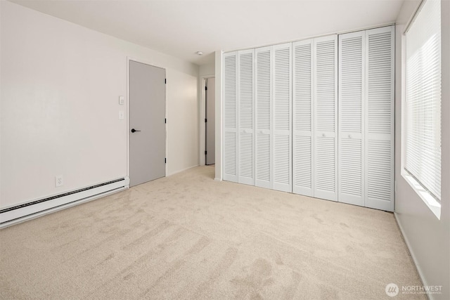 11012 NE 68th St Unit 511, Kirkland, WA 98033 - unfurnished bedroom with carpet, baseboard heating, multiple windows, and a closet