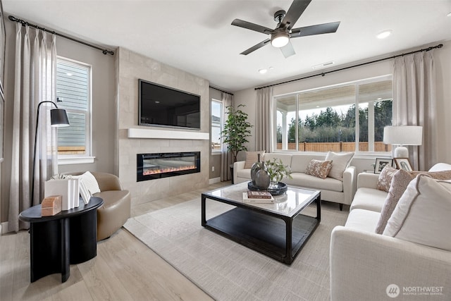13912 181st St E Unit 62, Puyallup, WA 98374 - living room with a tile fireplace, ceiling fan, wood finished floors, and recessed lighting