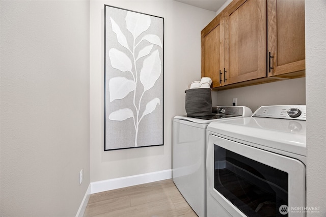 13912 181st St E Unit 62, Puyallup, WA 98374 - laundry room featuring washer and dryer, cabinet space, baseboards, and light wood-style floors