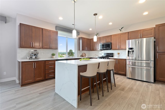 20325 90th Pl S, Kent, WA 98031 - kitchen featuring appliances with stainless steel finishes, light wood-style floors, light countertops, decorative backsplash, and recessed lighting