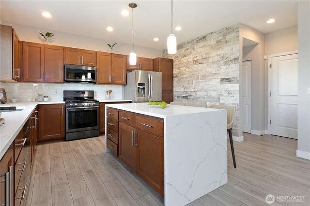 20325 90th Pl S, Kent, WA 98031 - kitchen featuring appliances with stainless steel finishes, light wood finished floors, recessed lighting, pendant lighting, and brown cabinetry