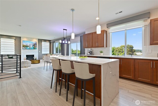 20325 90th Pl S, Kent, WA 98031 - kitchen with a sink, light wood-type flooring, tasteful backsplash, a kitchen island, and open floor plan