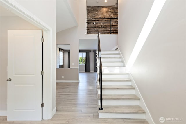 20325 90th Pl S, Kent, WA 98031 - stairs featuring baseboards, wood finished floors, and a towering ceiling