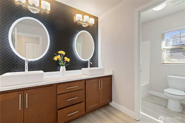 20325 90th Pl S, Kent, WA 98031 - full bath featuring wood finished floors, double vanity, toilet, and baseboards