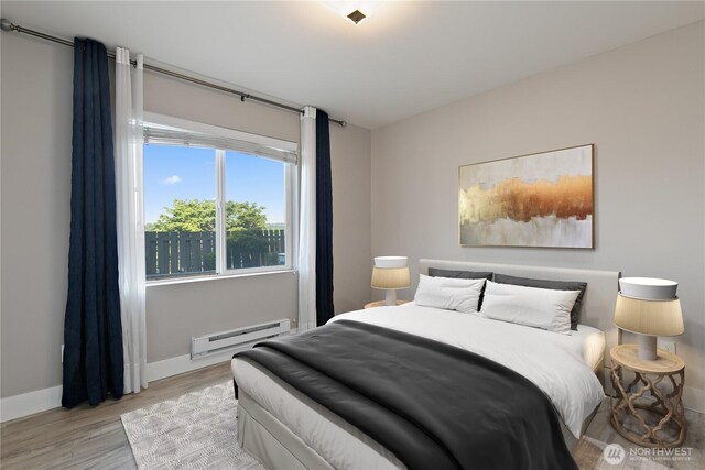 20325 90th Pl S, Kent, WA 98031 - bedroom with baseboard heating, light wood-type flooring, and baseboards